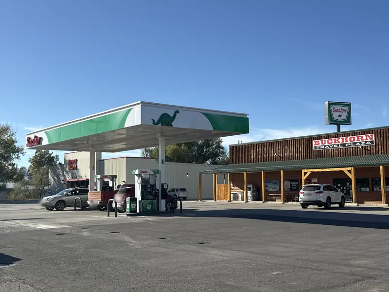 Sinclair gas station with the green dinosaur on the canopy, next to the Buckhorn Travel Plaza store.